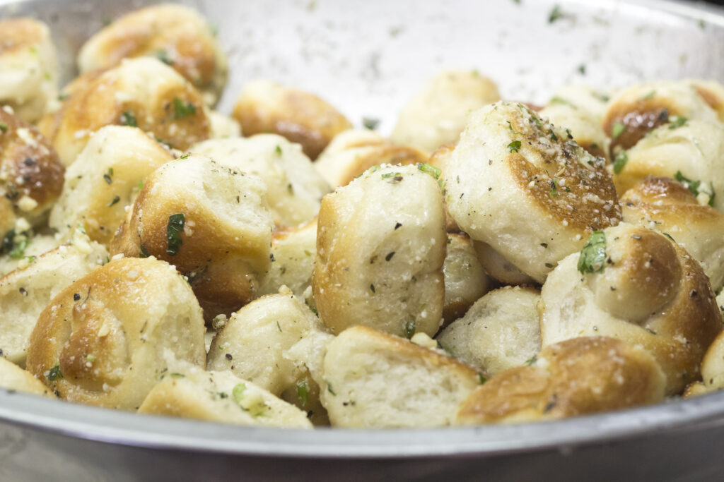 Buttery Garlic Knots tossing with Parmesan cheese and parsley